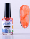 Flacon d'encre aquarelle orange 15 ml et son effet marbré sur un ongle