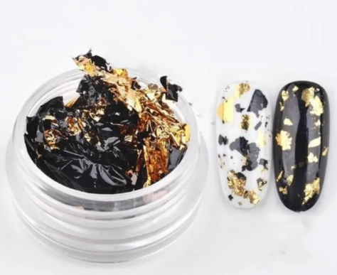 Pot de fragments de feuille métallique noir et or, et deux ongles témoins